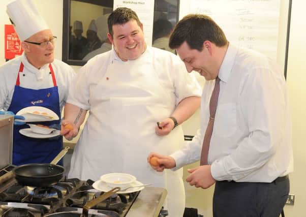 Employability minister Jamie Hepburn makes an omlette under the expert guidance of chef Mark Heirs. Photography by Whyler Photos of Stirling  www.whylerphotos.com