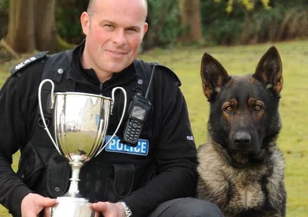 Ralph in his prime, with dog handler sergeant Colin Young.