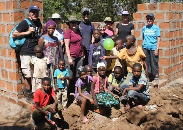 Anne, second from right, back row, with fellow volunteers and local people on the project's building site in Tanzania.