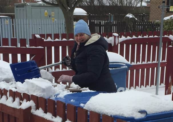 Shovel in hand, Councillor Meiklejohn toils cheerfully away