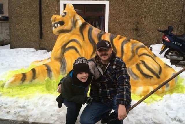 Murray and Sandy Robertson, from Carronshore, proudly pose in front of their snow tiger