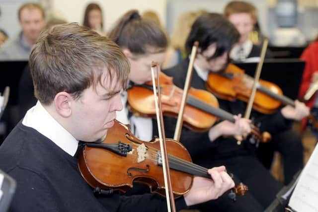 Pulling some strings...to turn sheet music into an orchestral performance, members of the senior schools' orchestra. (Pic: Michael Gillen)