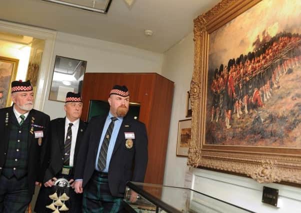 Argylls veterans studying the famous painting of the Thin Red Line in the museum in Stirling.