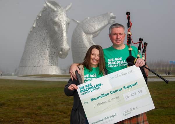 Larbert man Neil Clark proudly displays his latest fundraising total for Macmillan Cancer Support with wife Kathryn Grainger