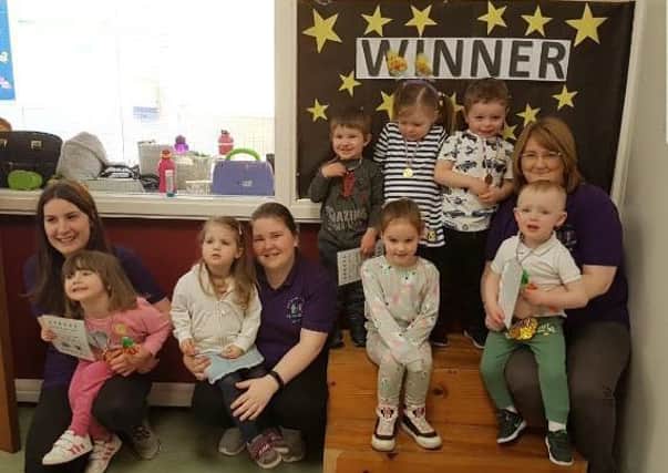 Grange Centre Play Group staff and children after sponsored obstacle course