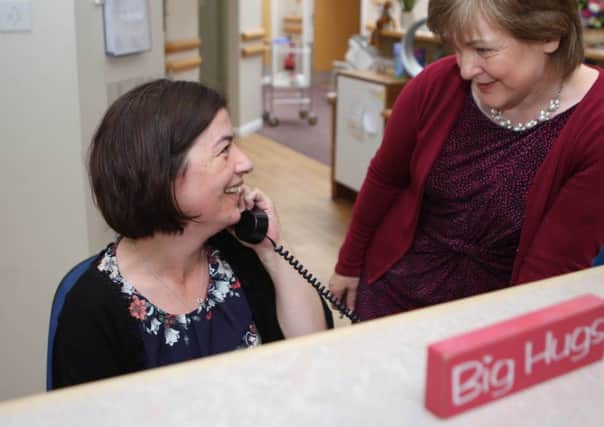 Anne, left, as her colleagues remember her best - on duty at Strathcarron Hospice.