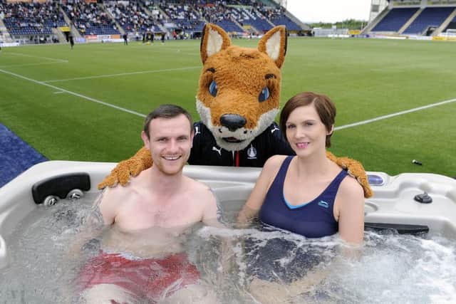Jamie Gow and Nikki Gow watched Falkirk vs Dumbarton from a pitchside hot tub. Picture: Michael Gillen.