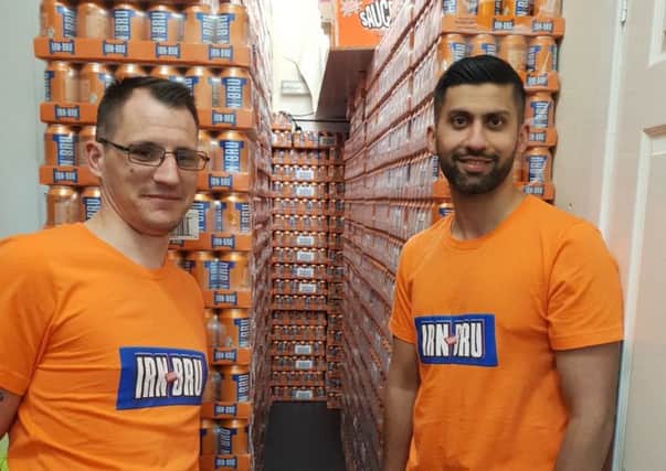 Day-Today Express shopkeeper Jawad Javed (right) got help transporting thousands of full-sugar Irn-Bru cans from friend Mike Grist (left)