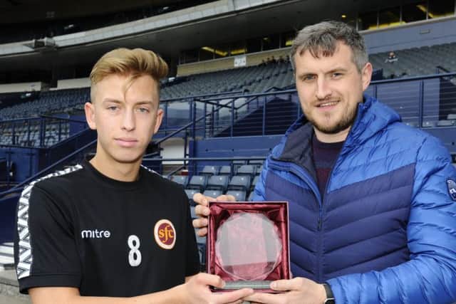 Sports Editor David Oliver hands over this year's Starshot trophy to Harry Paton. Picture: Alan Murray