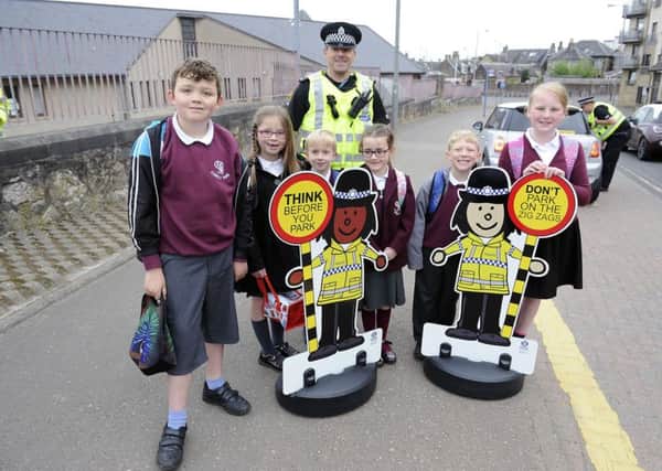 Comely Park Primary schoolchildren spread vital road safety messages to parents with help from police and the School Squad cut-outs