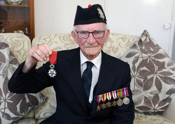 Jack Adamson proudly shows off his Legion of Honour medal. Picture by Michael Gillen