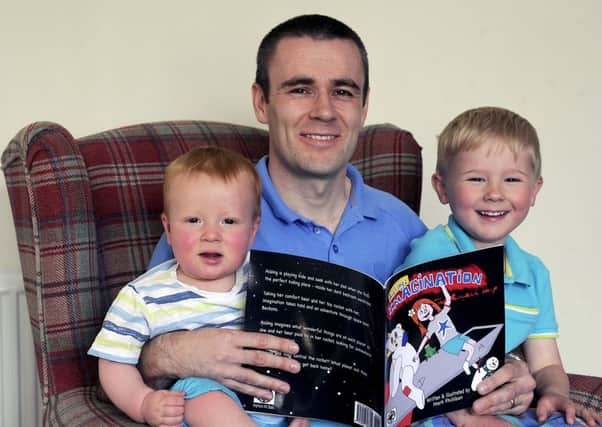 Proud dad...Mark Philliban is delighted to be able to read his very own picture book to his two sons, one year old Connor and four and a half year old Max. (Pic: Michael Gillen)
