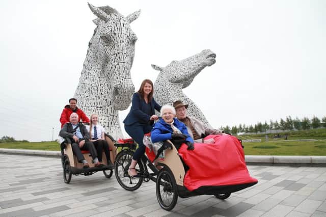 Public health minister Aileen Campbell takes Mary Duncan, 90, and Jim Taylor, 96,  for a spin at the Kelpies in Falkirk. Picture by Stewart Attwood
