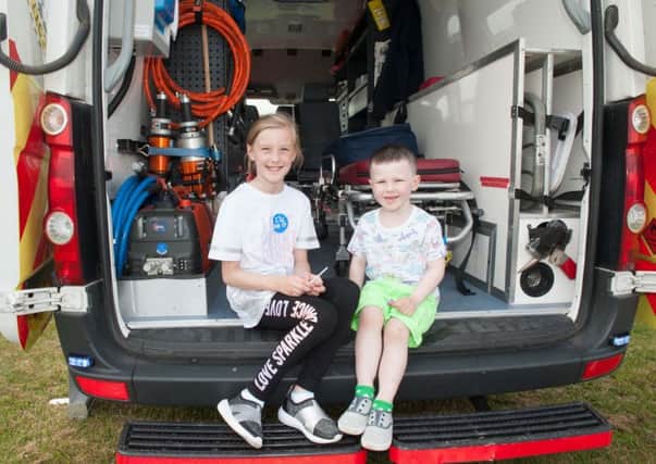 Lilly - May Gillies, aged 9, with her brother Jakob Gillies (4) take a look at an ambulance. Picture: Jamie Forbes