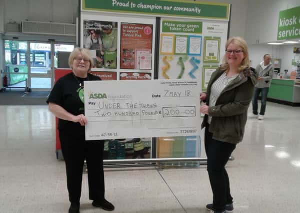 Asda Falkirk's Green Token Given scheme donated Â£200 to the outdoor learning Under the Trees organisation