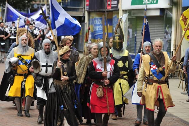 Knights, in their historic heraldry, lead the parade from the town centre.