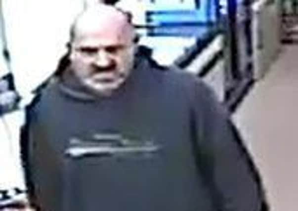 Police want to speak to the pictured man in connection with a robbery at a convenience store in Greenbank Court, Camelon