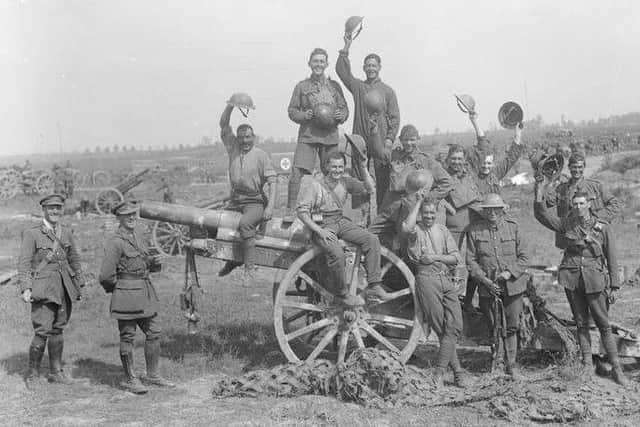 Following the capture of Grevillers by the New Zealand Division, Men of the Royal Garrison Artillery pose beside one of the 4.2 inch guns of a captured battery at Grevillers, 25 August 1918. Note the camouflage netting on the ground, which was designed to prevent the guns from being spotted from the air. Â© IWM (Q 11243)