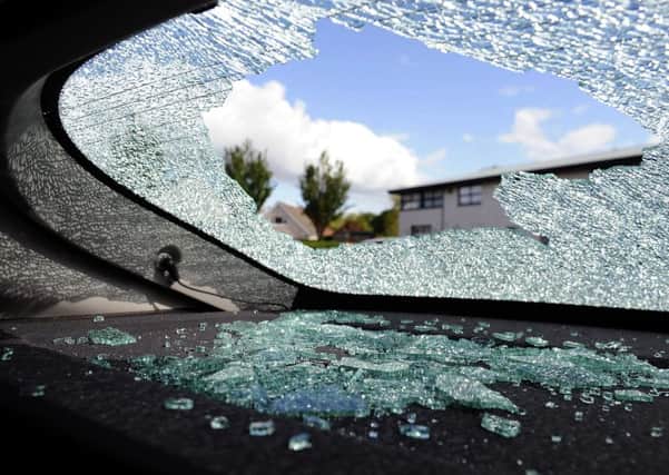 Ward smashed windows in two cars with the same concrete block