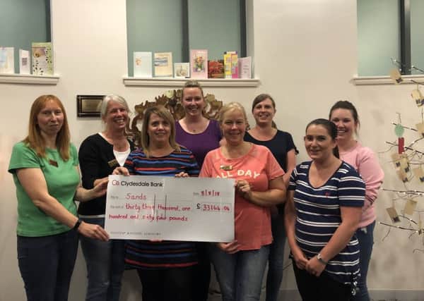 Kellie Cunningham (front and centre) hands over the cheque for Â£33,000 to the team of Forth Valley Stillbirth and Neonatal Deaths volunteers