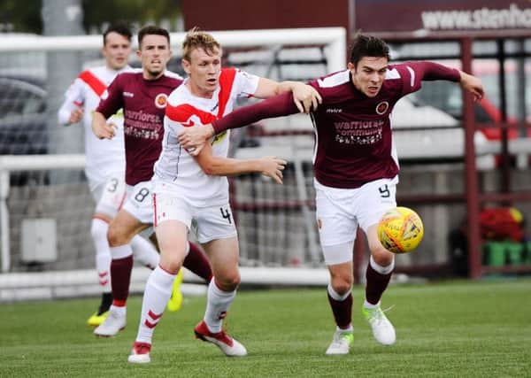 Stenhousemuir's Mark McGuigan is shadowed by Jonathan Page of Airdrieonians (picture by Alan Murray)