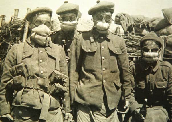 Men of the Argylls, wearing gas masks, in the trenches on the Western Front.