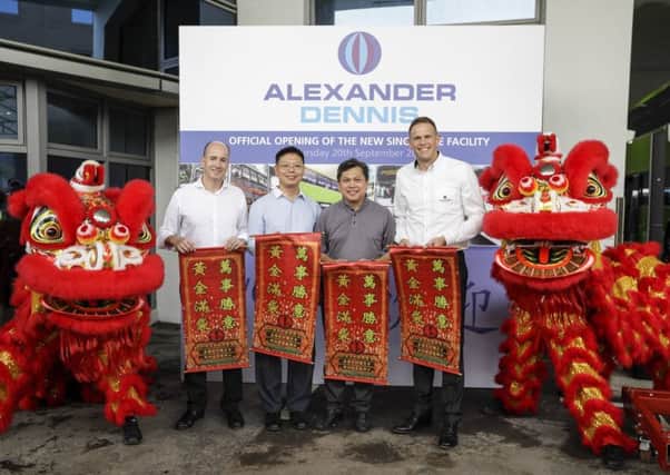 Alexander Dennis staff celebrate the firm's expansion into Singapore
