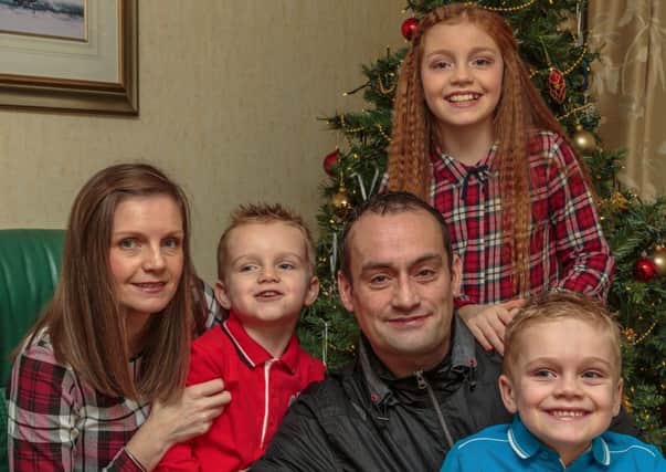 Lynne Black and children Karis, Logan and Lewis are pictured celebrating Christmas with Steven, who died in February last year. Picture: Bob Black