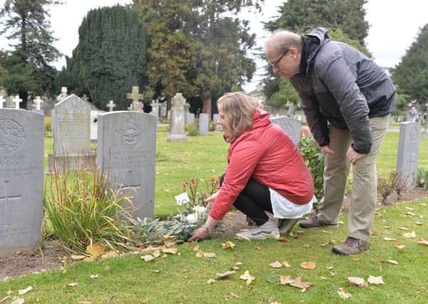 Elizabeth Preni and Colin Jenner place a floral tribute to their great uncle William Crichton. Picture: Damien Maddock