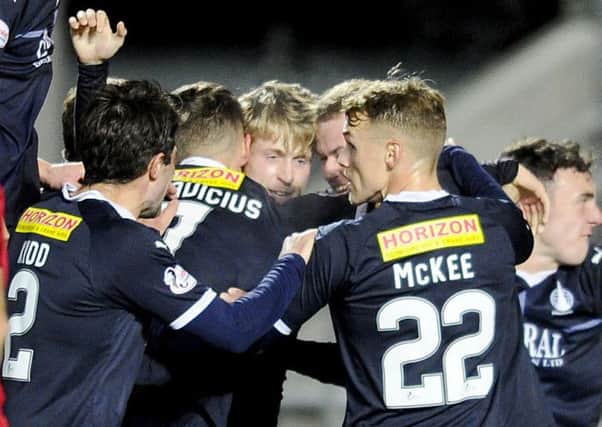 Tomm Robosn is mobbed after Falkirk's goal on Tuesday. Picture Michael Gillen