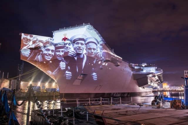 Prisoners of war...sailors returning home are shown on the side of HMS Prince of Wales in Rosyth during the video.