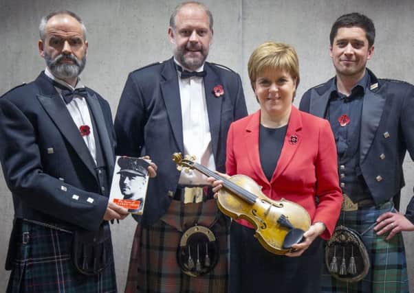First Minister Nicola Sturgeon takes a closer look at the 'Wilfred Owen violin' - a unique instrument fashioned from a sycamore tree, which was made at Craiglockhart Hospital while the famous war poet (later to die in action) was recuperating.