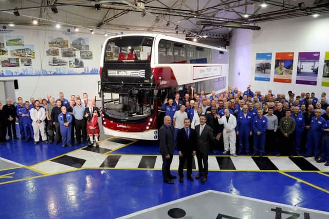 Alexander Dennis Limited employees proudly present the vehicle to Richard Hall, Lothian Buses managing director, and Falkirk West MSP Michael Matheson
