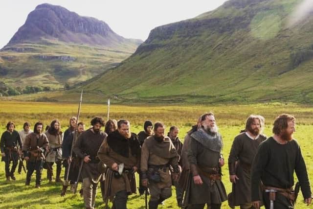 Tony Curran, as Hebridean warlord Angus Og MacDonald, leads a file of Bruce supporters through the Highlands.