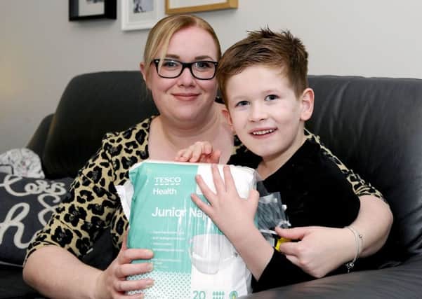 Laura Rutherford and Brody (6) with the nappies she helped design. Picture: Michael Gillen.