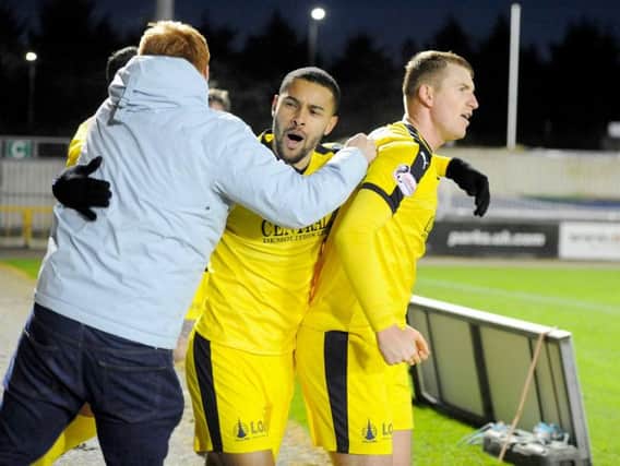Dennon Lewis and Harrison celebrate with fans (Pic: Michael Gillen)