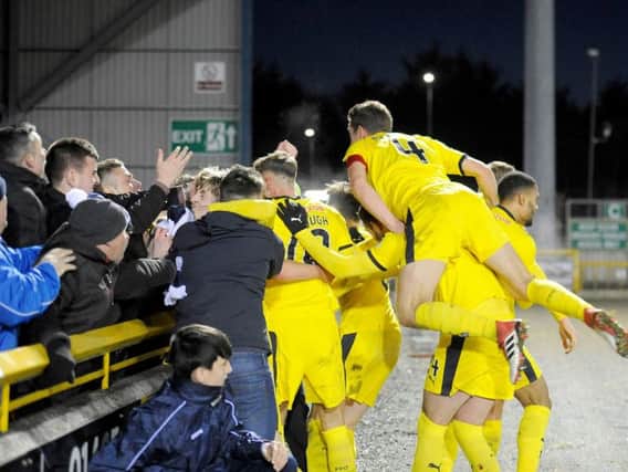 Falkirk players celebrate with supporters after Scott Harrison's 93rd minute winner. (Pic: Michael Gillen)