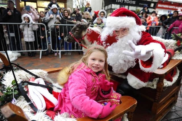 Lucky Millie Bentall (7) won a competition to ride with Santa on his sleigh.