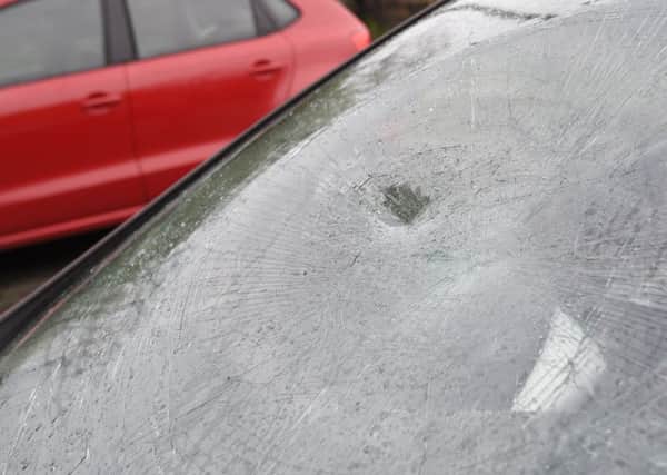 Several cars, as well as school windows, were damaged by vandals in Langlees