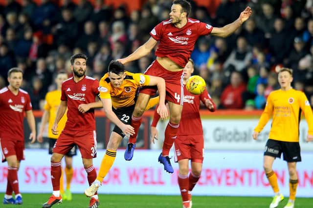 Andrew Considine and Connor McBrearty compete for the ball