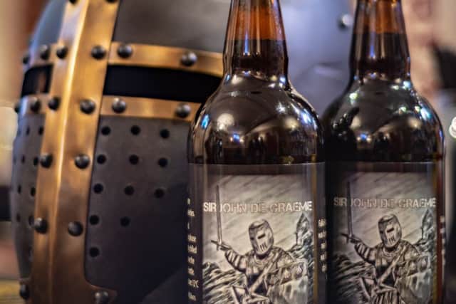 The Sir John de Graeme ale - shown alongside the sort of helmet the knightly class once wore in battle.  Picture courtesy Scotdrone