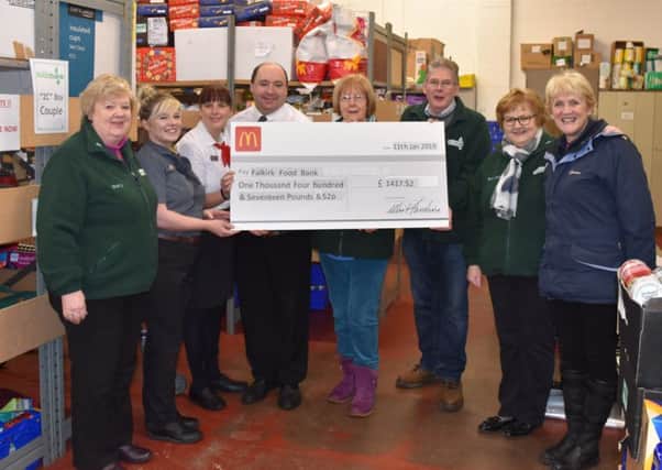 Falkirk Foodbank takes delivery of a bumper cheque from McDonald's staff.