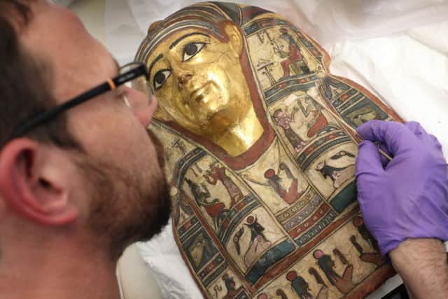 Discovering history...conservator Charles Stable works on an ancient Egyptian mummy mask. (Pic: Stewart Attwood)