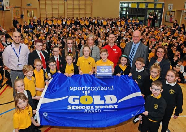 Maddiston Primary pupils and teaching staff are presented with their award by sportscotland chief executive Stewart Harris. Picture: Michael Gillen