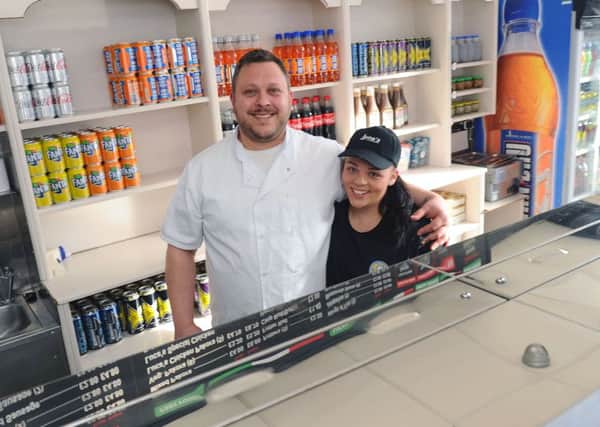 Luca and Lory Fragnoli are now following in the footsteps of chippy owner Enrico Tomassi by running the Main Street shop in Larbert. Picture: Michael Gillen