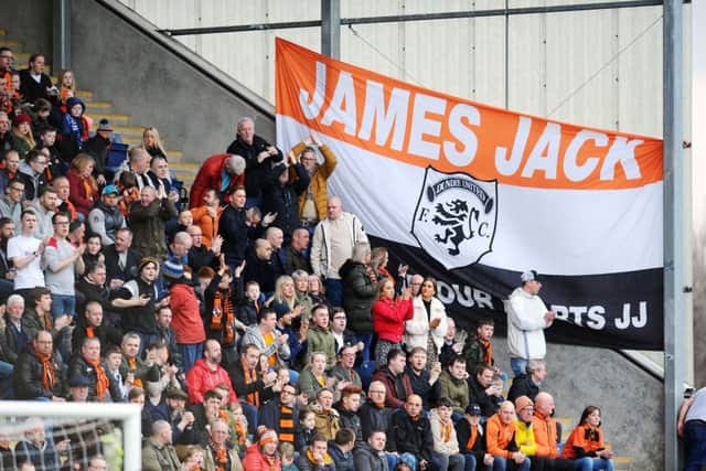 United fans dodged health and safety to scale the siding of the north stand to hang this banner.