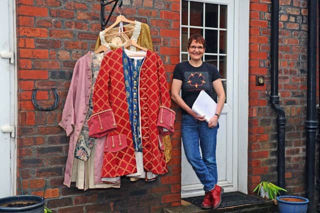 Helen Bang with some of the colourful costumes which will be worn on stage.