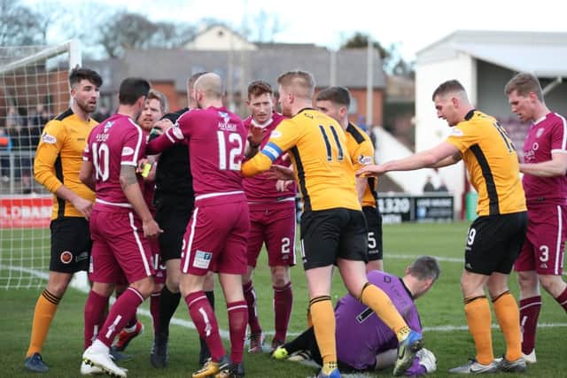 The players are embroiled towards the end of the game. Picture: Graham Black