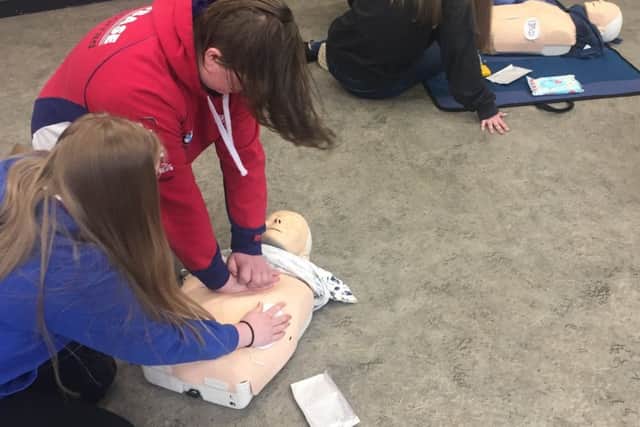 CPR techniques being taught to young leaders