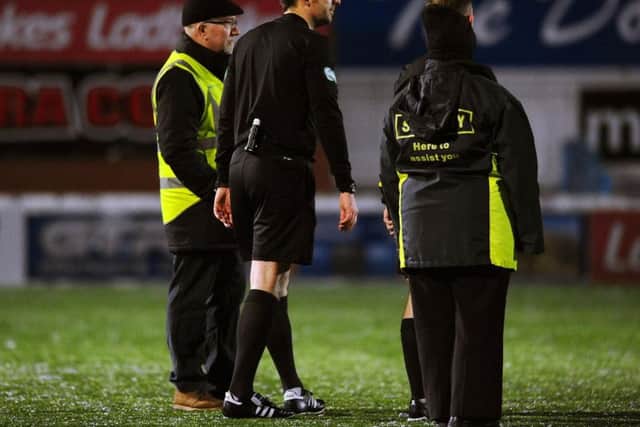 Referee Barry Cook was centre of stoppage time attention
